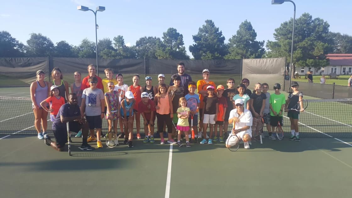 Junior players and coaches on the green court at King's Court, 2016.
